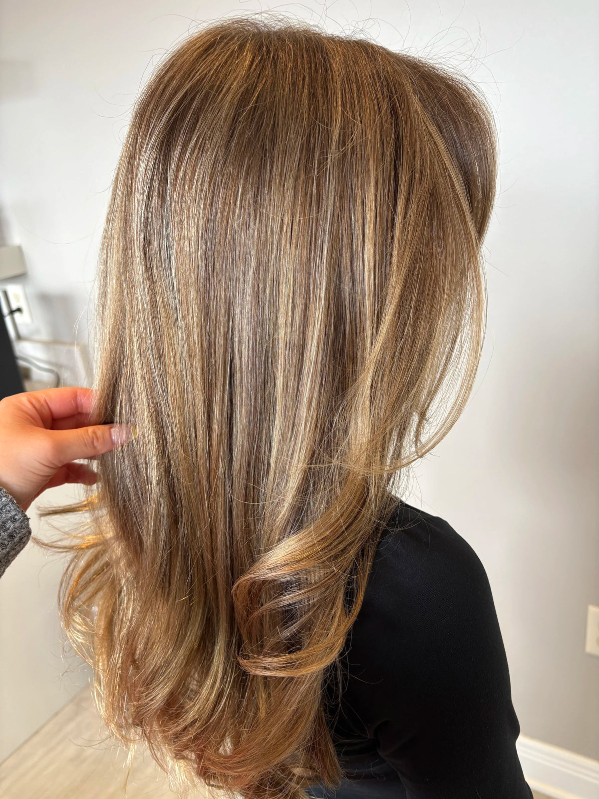 Long layered hair with soft highlights after a blowout