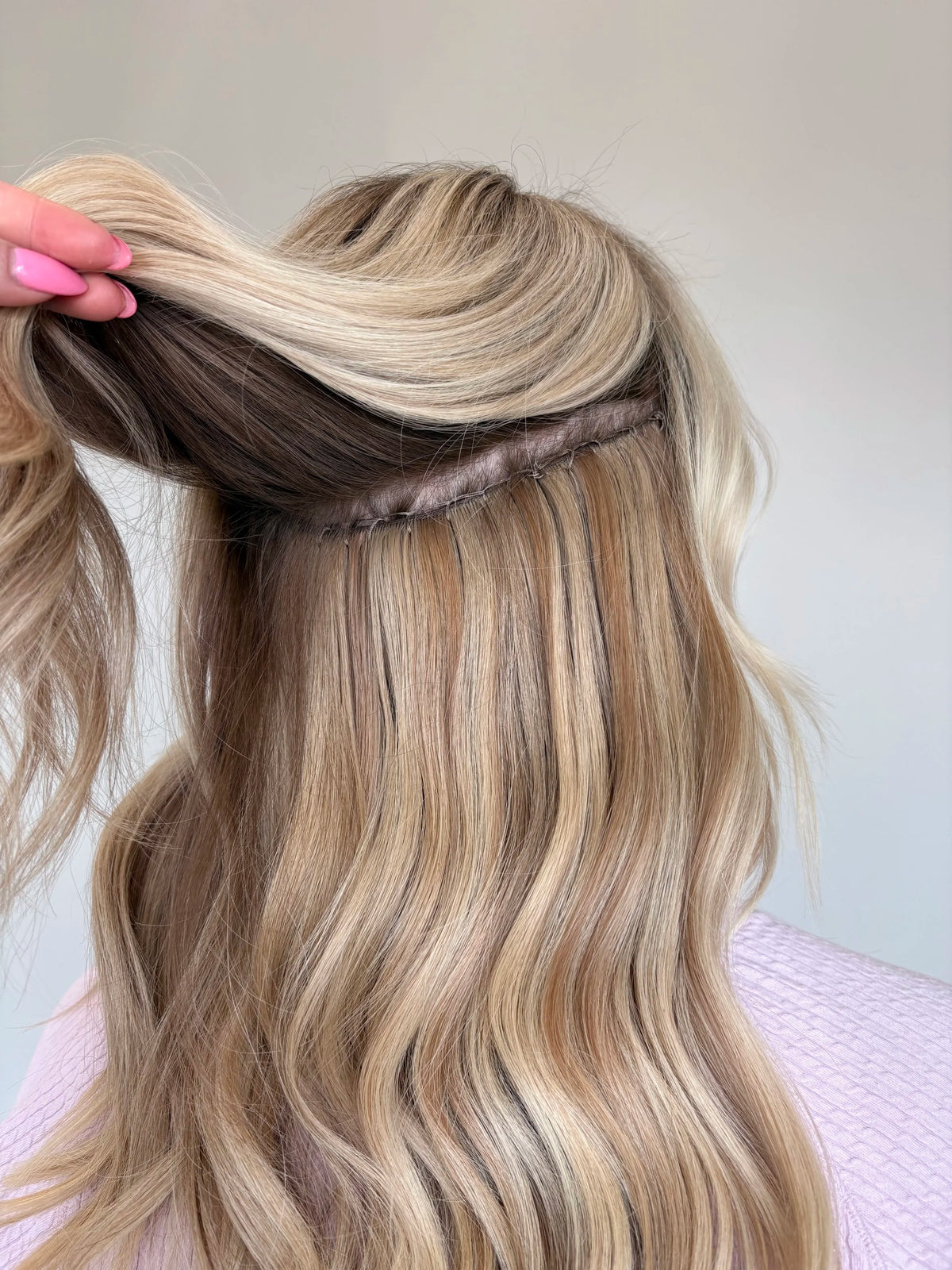 Hand tied weft extensions blended into blonde hair