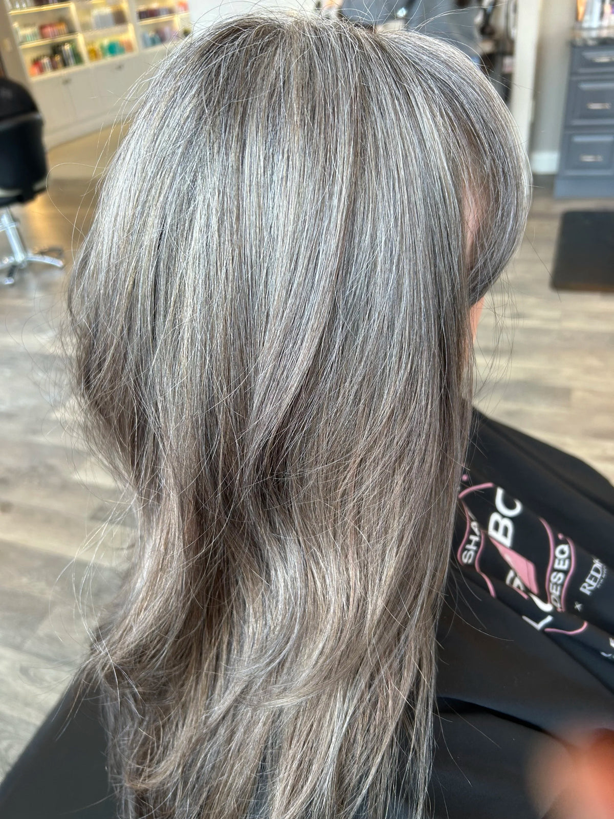 Soft grey blended color on layered hair, side view
