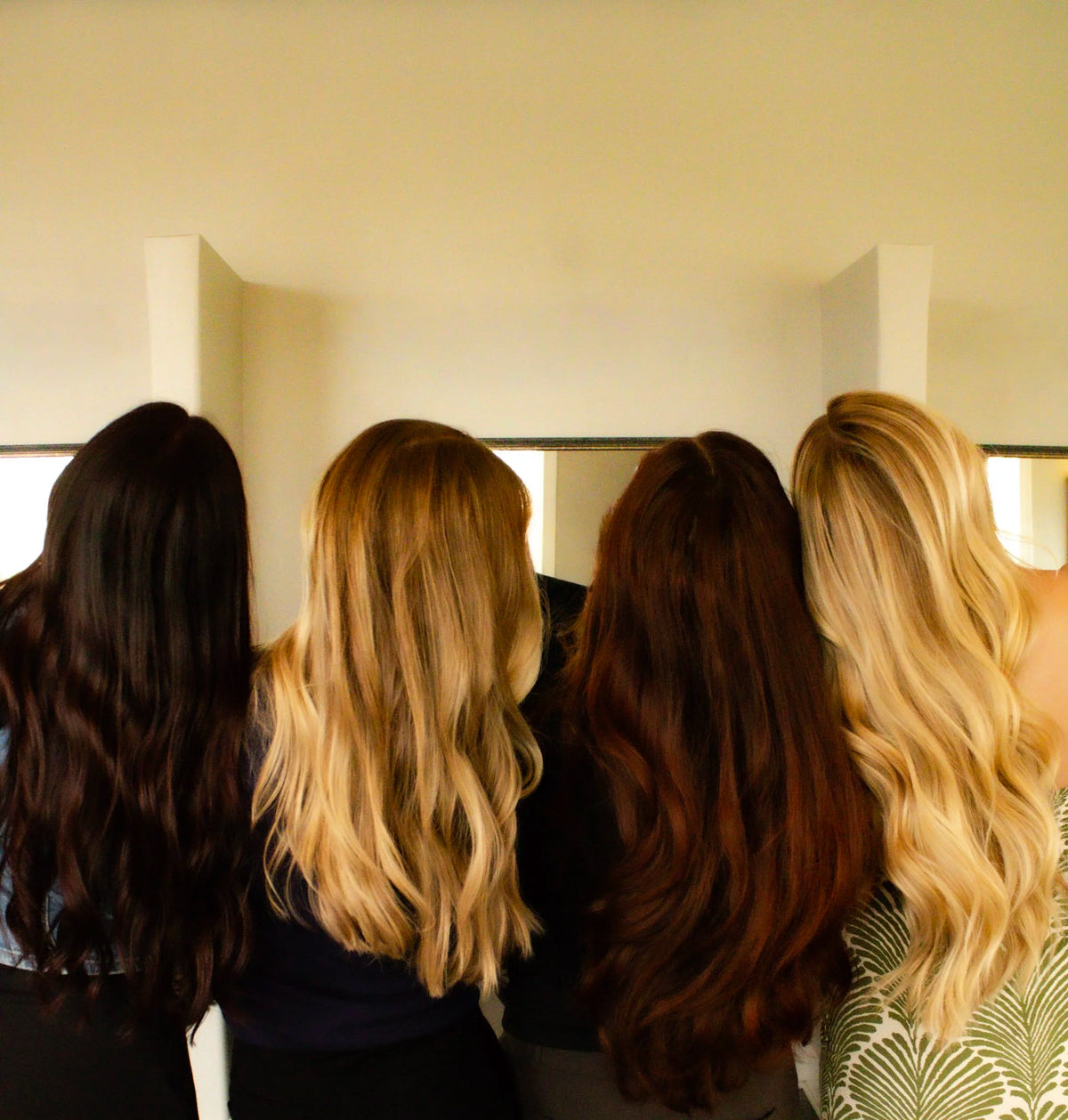 Four women from behind with long styled hair