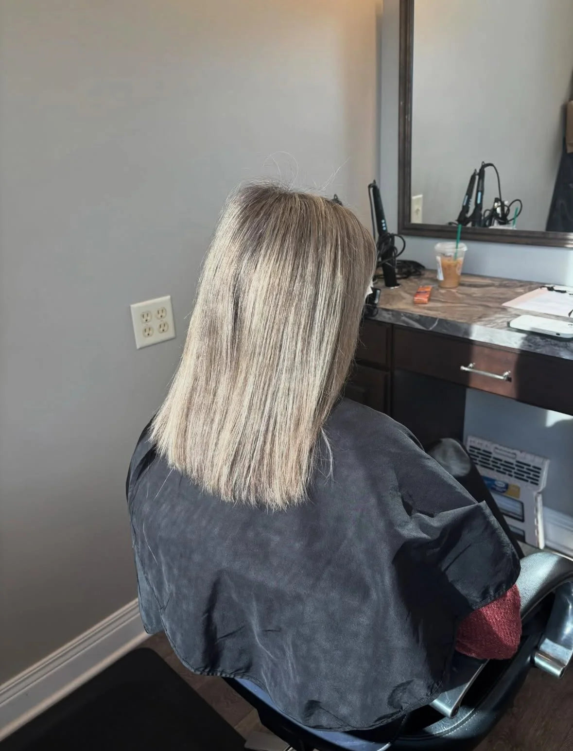 Short blonde hair before a hair extensions service, client seated in the salon chair
